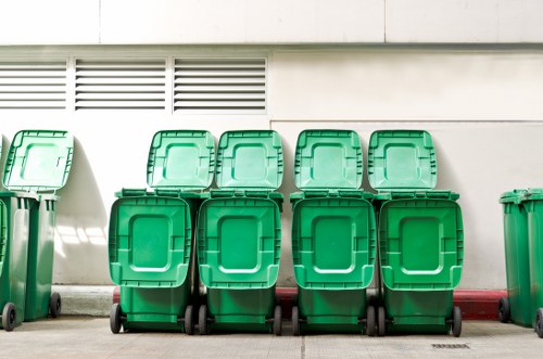 Builder loading waste into a skip near Marylebone High Street